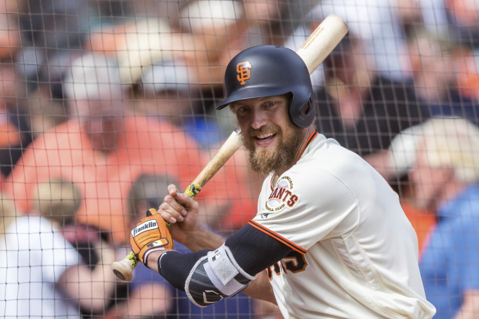 FILE - In this Sept. 30, 2018, file photo, San Francisco Giants Hunter Pence waits on deck club before batting against the Los Angeles Dodgers in the ninth inning of a baseball game in San Francisco. Pence is returning to the Giants, agreeing to a contract that will give the young club a veteran presence in both the outfield and clubhouse in a season of big change ahead. A person with direct knowledge of the deal said Friday, Feb. 7, 2020, that Pence had reached agreement pending a physical. The person spoke to The Associated Press on condition of anonymity because no announcement had been made. (AP Photo/John Hefti)