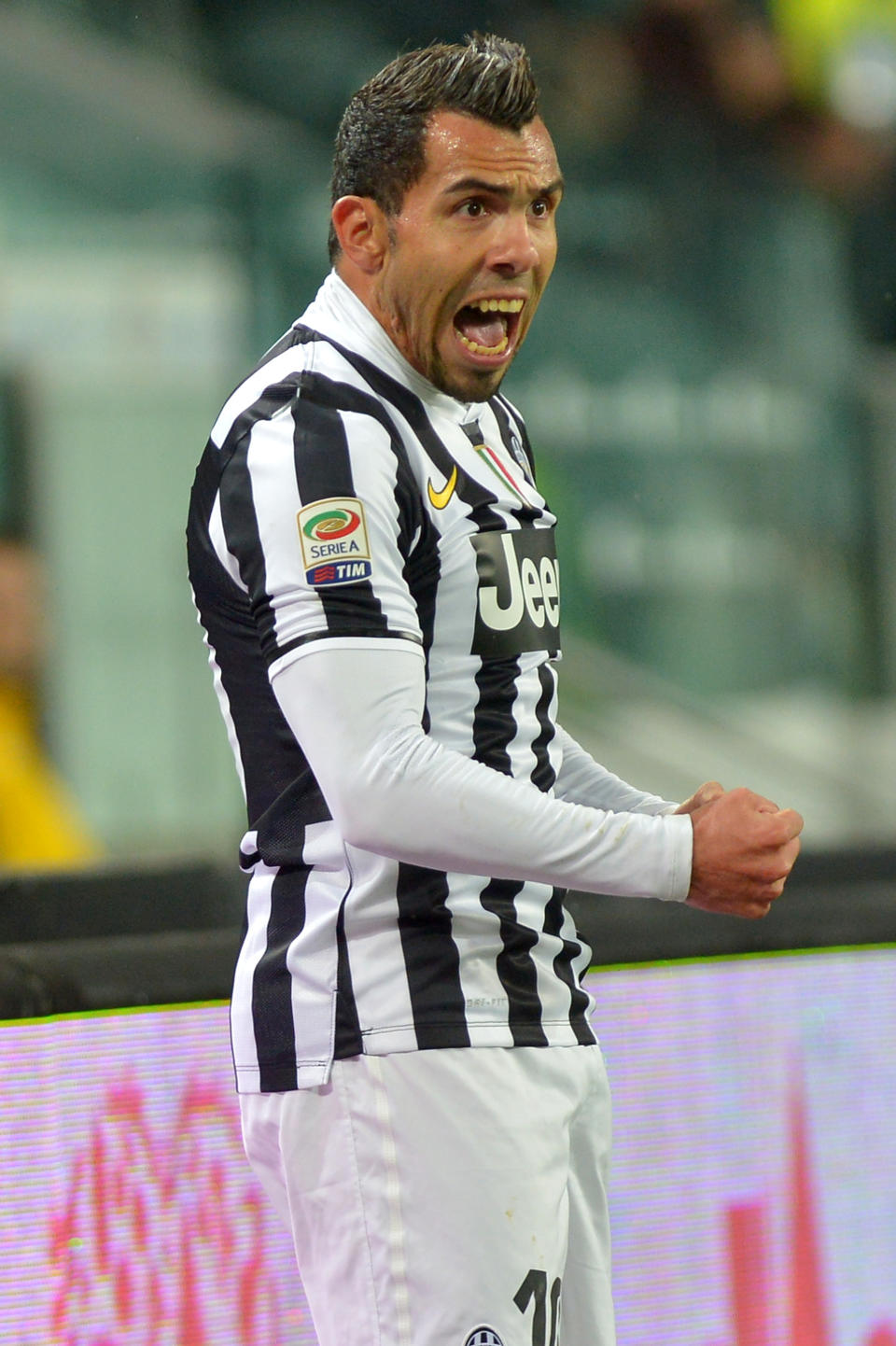 Juventus forward Carlos Tevez, of Argentina, celebrates after scoring during a Serie A soccer match between Juventus and Parma at the Juventus stadium, in Turin, Italy, Wednesday, March 26, 2014. (AP Photo/Massimo Pinca)