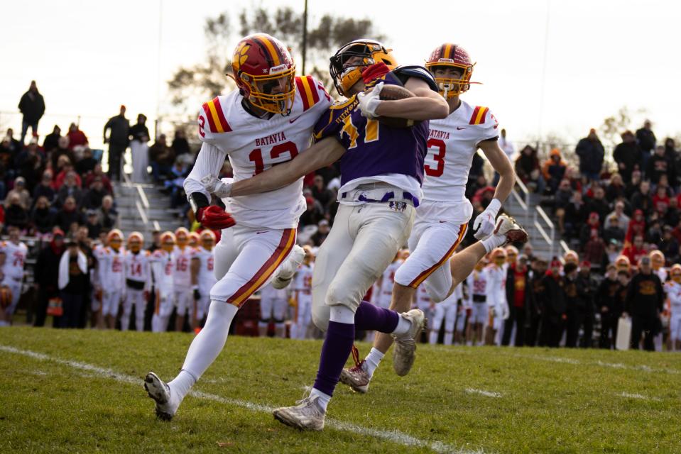 Hononegah high school wide receiver Joseph Melcher (17) catches a pass against off Batavia's Luke Alwin (12) on Nov. 11, 2023 during a playoff game at Hononegah High School.