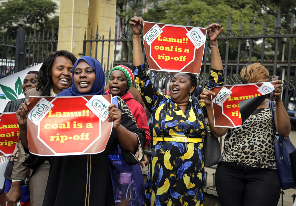 Environmental activists celebrate their victory outside the supreme court building, after a tribunal ruling on the construction of a coal-fired power plant, in Nairobi, Kenya Wednesday, June 26, 2019. The Kenyan tribunal blocked the construction of the government-backed plant in Lamu County, which hosts a UNESCO world heritage site and which activists said would cause environmental damage. (AP Photo/Khalil Senosi)
