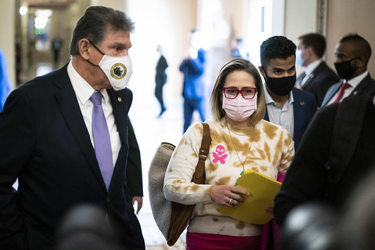 Sens. Joe Manchin and Kyrsten Sinema depart after a Democratic policy luncheon on Capitol Hill on Nov. 16, 2021. (Photo by Jabin Botsford/The Washington Post via Getty Images)