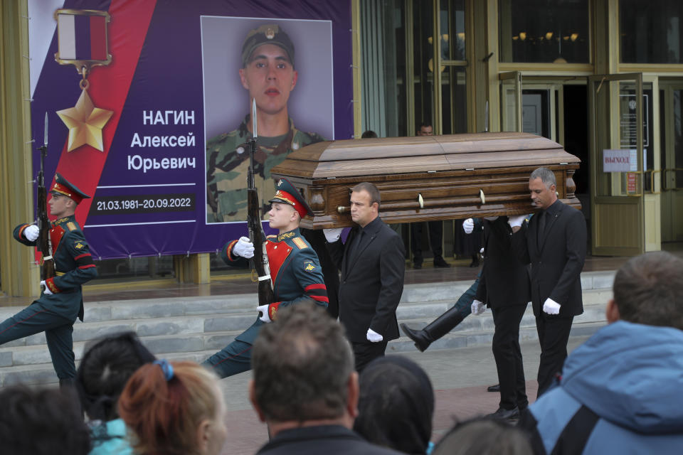 FILE - Honor guards escort the coffin of Alexei Nogin, who was killed in combat in Ukraine, during a mourning ceremony, in Volgograd, Russia, on Sept. 24, 2022. Nogin who was the commander of one of the assault detachments of the Wagner Group was posthumously awarded with the Hero of Russia medal for fighting in Ukraine. Russia's Wagner Group, a private military company led by Yevgeny Prigozhin, a rogue millionaire with longtime links to Russia's President Vladimir Putin, has played an increasingly visible role in the fighting in Ukraine. (AP Photo, File)