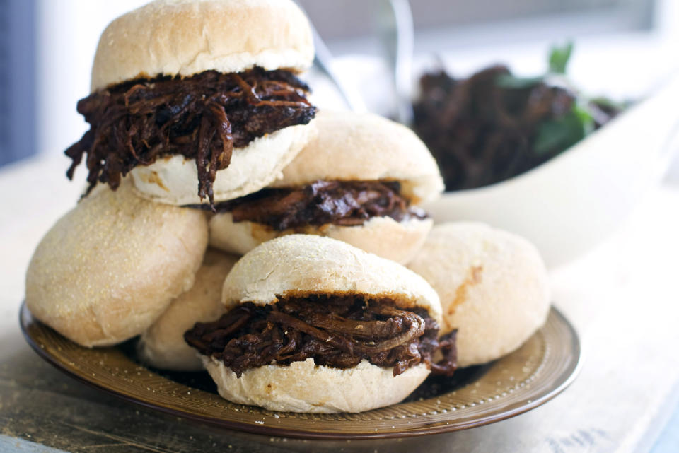 In this image taken on Nov. 12, 2012, sweet-and-tangy barbecue brisket sliders are shown served on a bun in Concord, N.H. (AP Photo/Matthew Mead)