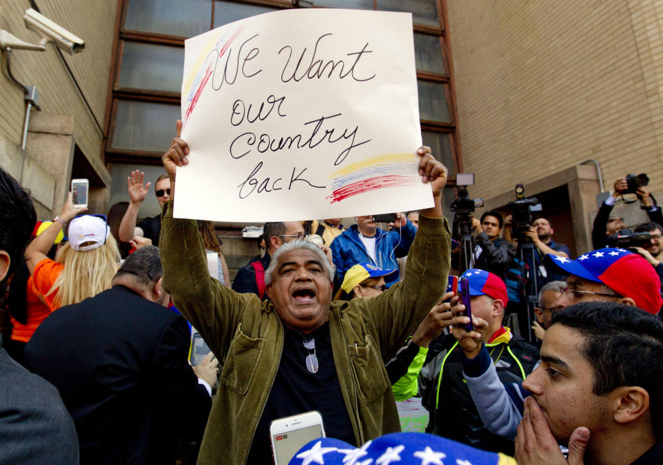 Opposition leader Juan Guaido supporters celebrate during the eviction and arrest of Nicolas Maduro's supporters from the Venezuelan Embassy in Washington, Thursday, May 16, 2019. (AP Photo/Jose Luis Magana)