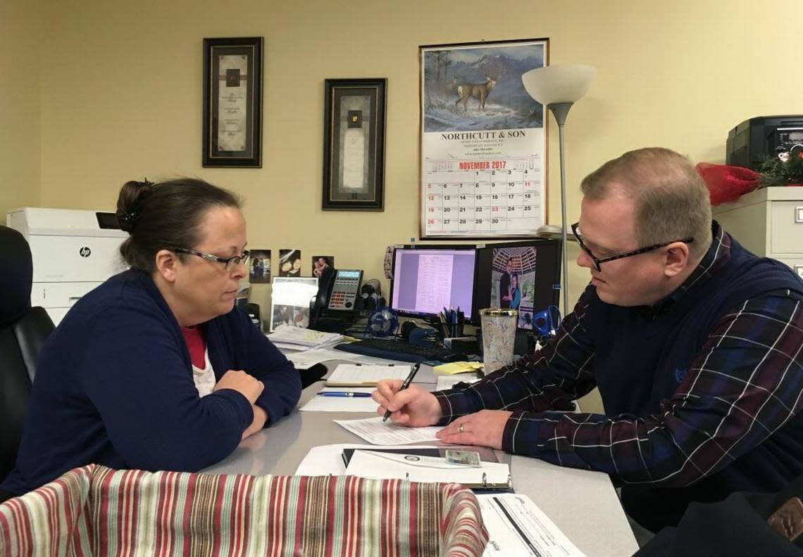 David Ermold, right, files to run for Rowan County Clerk in Kentucky as Clerk Kim Davis look on Wednesday, Dec. 6, 2017, in Morehead, Ky. Davis denied Ermold and his husband a marriage license two years ago because she was opposed to gay marriage for religious reasons.
