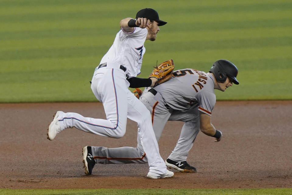 Miami Marlins third baseman Brian Anderson tags San Francisco Giants' Mike Yastrzemski (5) during the first inning of a baseball game, Sunday, April 18, 2021, in Miami. (AP Photo/Marta Lavandier)