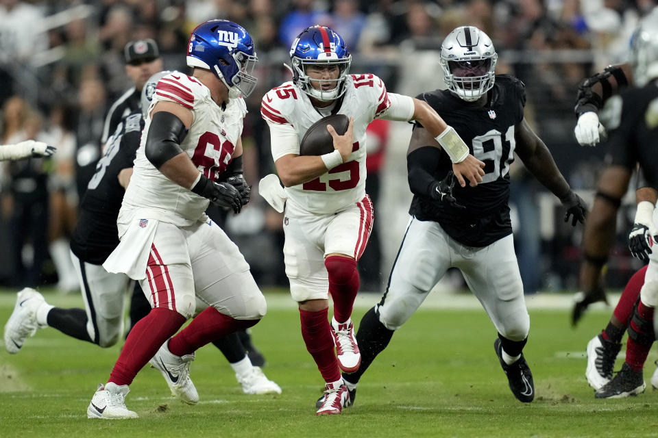 New York Giants quarterback Tommy DeVito (15) scrambles against the Las Vegas Raiders during the second half of an NFL football game, Sunday, Nov. 5, 2023, in Las Vegas. (AP Photo/John Locher)