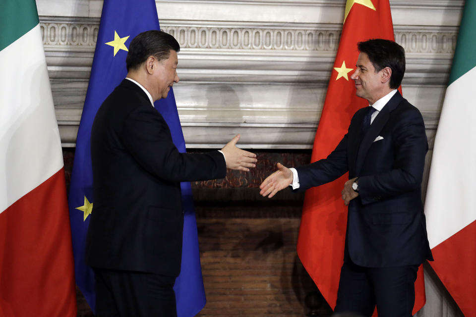 Chinese President Xi Jinping, left, and Italian Premier Giuseppe Conte shake their hands at the end of the signing ceremony of a memorandum of understanding at Rome's Villa Madama, Saturday, March 23, 2019. Italy signed a memorandum of understanding with China on Saturday in support of Beijing's "Belt and Road" initiative, which aims to weave a network of ports, bridges and power plants linking China with Africa, Europe and beyond. (AP Photo/Andrew Medichini)