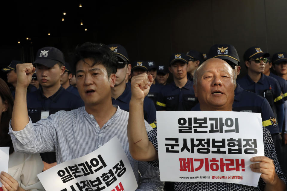 South Korean protesters shout slogans during a rally demanding the South Korean government to abolish the General Security of Military Information Agreement, or GSOMIA, an intelligence-sharing agreement between South Korea and Japan, in front of Japanese embassy in Seoul, South Korea, Thursday, Aug. 22, 2019. The letters read "Abolish the General Security of Military Information Agreement, or GSOMIA. (AP Photo/Lee Jin-man)