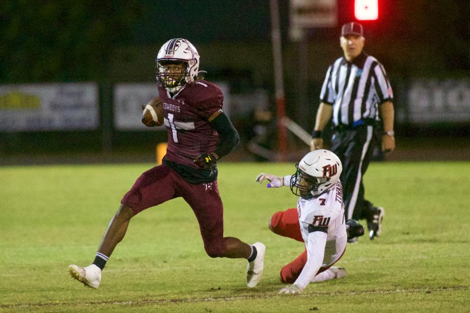 Madison County senior Jonathan Akins (1) avoids a Fort White tackle on a punt return.