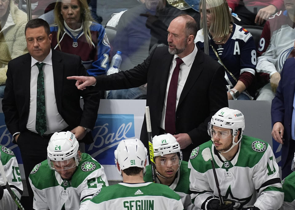 Dallas Stars coach Peter DeBoer, back right, directs players during the third period of Game 3 of the team's NHL hockey Stanley Cup playoff series against the Colorado Avalanche on Saturday, May 11, 2024, in Denver. (AP Photo/David Zalubowski)