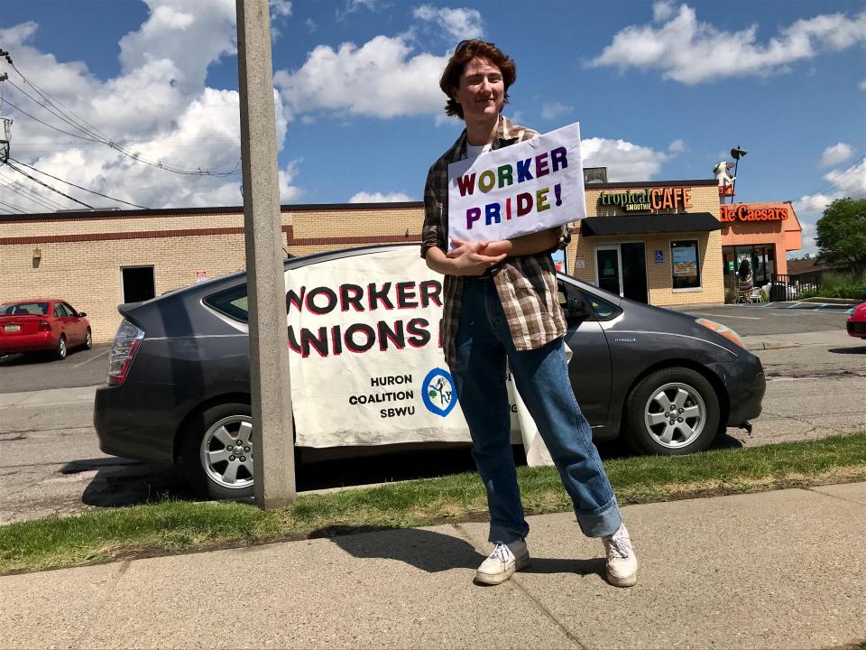 Lansing Township barista Olivier Stroud holds a sign during a union vote count at an East Lansing Starbucks on June 9, 2022.