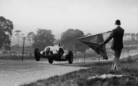 A Mercedes W 125 racing car in dramatic action at the Donington Park Grand Prix. The race was won by German racing driver Berndt Rosemeyer in an Auto Union. (Photo by Fox Photos/Getty Images) - Credit: Fox Photos/Hulton Archive