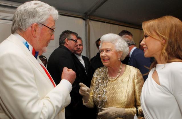 FILE PHOTO: Queen Elizabeth meets Australian entertainers Rolf Harris and Kylie Minogue backstage at the Diamond Jubilee Concert outside Buckingham Palace in London