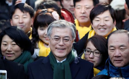 FILE PHOTO: Moon Jae-in (C), former human rights lawyer and presidential candidate of the main opposition Democratic United Party, attends a campaign encouraging people to vote, in Seoul, South Korea December 19, 2012. REUTERS/Kim Hong-Ji/File Photo
