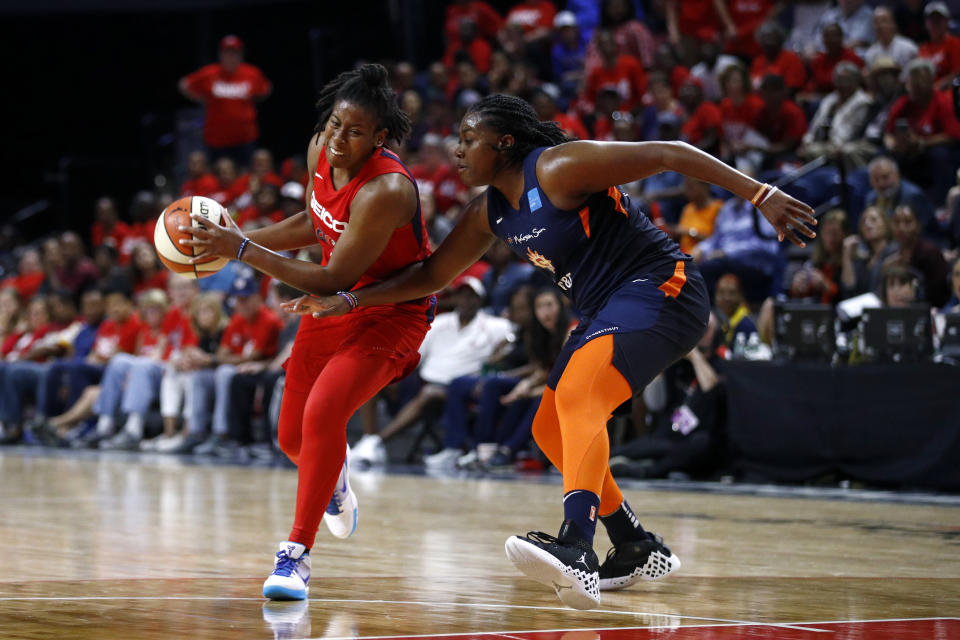 Washington Mystics guard Ariel Atkins, left, drives against Connecticut Sun forward Shekinna Stricklen in the second half of Game 1 of basketball's WNBA Finals, Sunday, Sept. 29, 2019, in Washington. (AP Photo/Patrick Semansky)