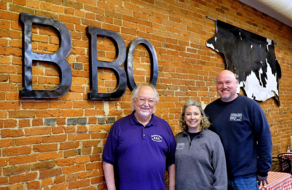 Retiring Bob Workman with daughter Jenna and son-in-law Joe Laughlin, the new owners of Omahoma Bob's restaurant in downtown Wooster.