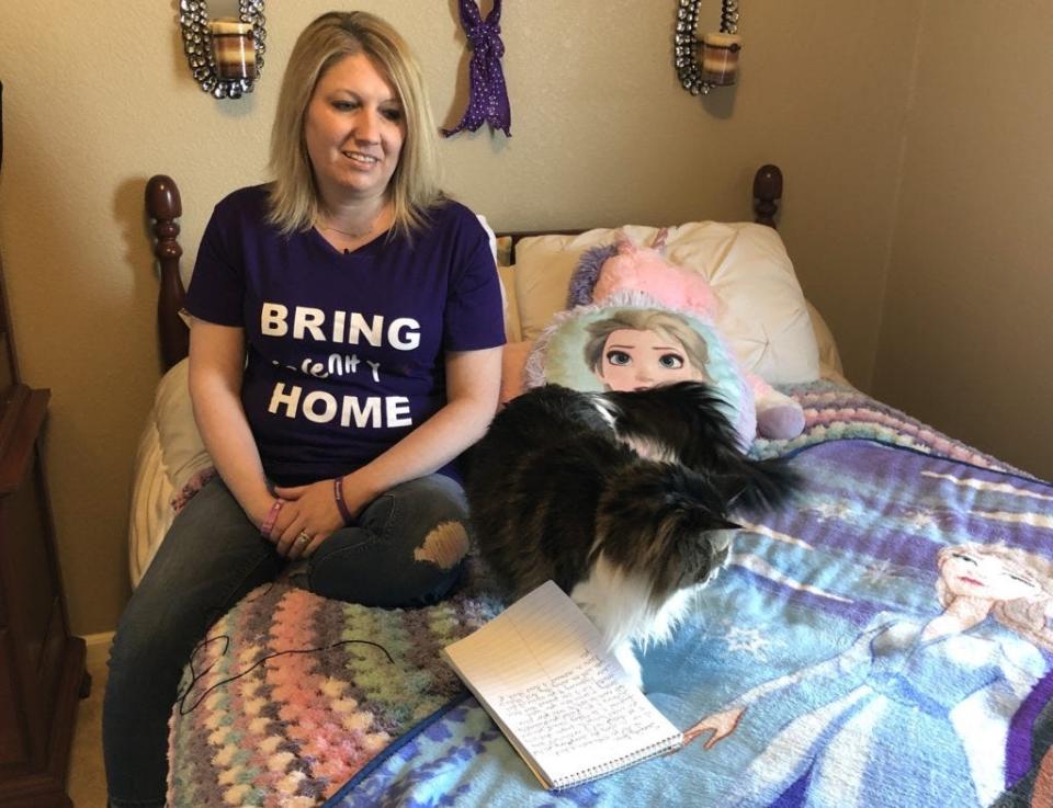 Darcie Gentry, Serenity Dennard’s legal adoptive mother, sits on the bed she keeps made for Serenity in case the missing girl ever comes home. Gentry said Serenity loved their cat, Stella, whose presence helps keeps Serenity close to Gentry’s heart.