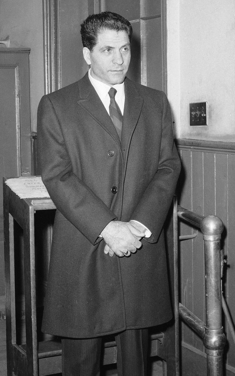 John "Sonny" Franzese waits to be booked at the Elizabeth Street police station in New York, after his arrest - Credit: Anthony Camerano/AP