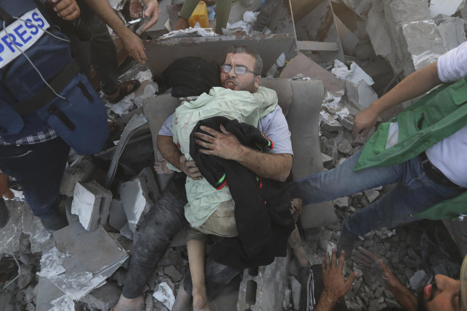 An injured Palestinian man hugs an injured relative after being rescued following Israeli airstrikes on Gaza City, Wednesday, Oct. 25, 2023. (AP Photo/Abed Khaled)