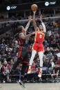 Atlanta Hawks guard Dejounte Murray, right, shoots over Chicago Bulls forward DeMar DeRozan during the first half of an NBA basketball game in Chicago, Monday, April 1, 2024. (AP Photo/Nam Y. Huh)