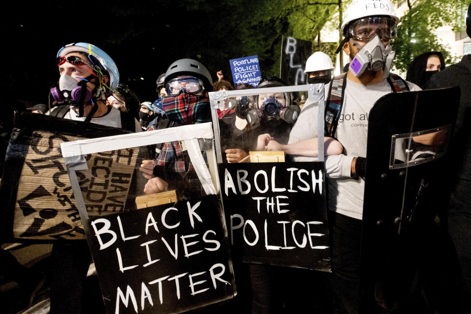 Black Lives Matter protesters march through Portland, Ore. after rallying at the Mark O. Hatfield United States Courthouse on Sunday, Aug. 2, 2020. Following an agreement between Democratic Gov. Kate Brown and the Trump administration to reduce federal officers in the city, nightly protests remained largely peaceful without major confrontations between demonstrators and officers. (AP Photo/Noah Berger)