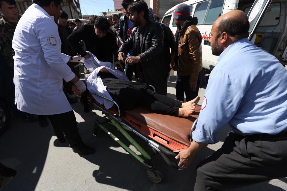 An injured woman is evacuated after a suicide bombing in Kabul, Afghanistan, Wednesday, March 1, 2017. An Afghan official says that a suicide car bomber attacked at the gates of a police station in the western part of the capital, Kabul. (AP Photo/ Rahmat Gul)