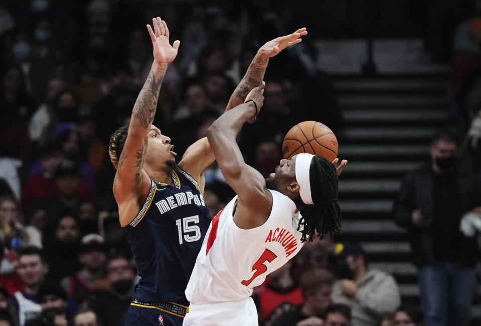 Toronto Raptors forward Precious Achiuwa (5) drives as Memphis Grizzlies forward Brandon Clarke (15) defends during the first half of an NBA basketball game Tuesday, Nov. 30, 2021, in Toronto. (Nathan Denette/The Canadian Press via AP)