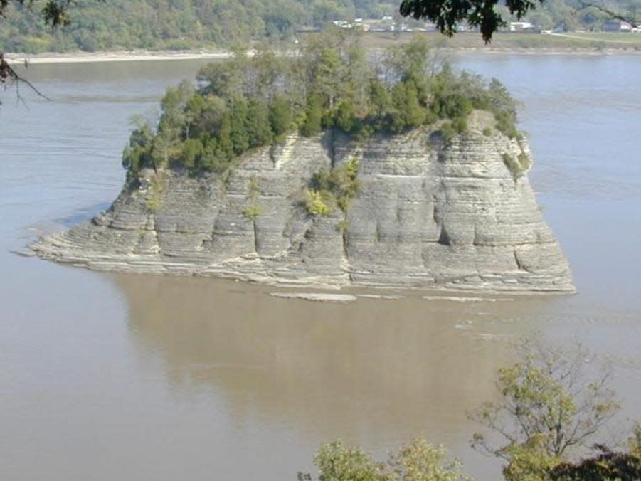 Photo of a 60-ft limestone rock surrounded by water