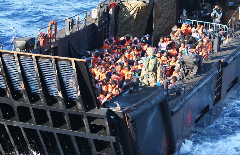 A landing craft prepares to dock onto HMS Bulwark after rescuing around 100 migrants from an inflatable boat off the coast of Libya on May 13, 2015