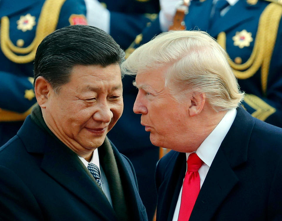 In this Nov. 9, 2017, file photo, U.S. President Donald Trump, right, chats with Chinese President Xi Jinping during a welcome ceremony at the Great Hall of the People in Beijing. (AP Photo/Andy Wong, File)