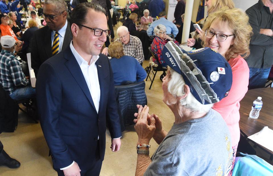 Pennsylvania Governor Josh Shapiro speaks with Doris Philhower, 79, near right, during a visit to the Erie West Senior Center on May 4. Center Director Lisa Reynolds is at back right.