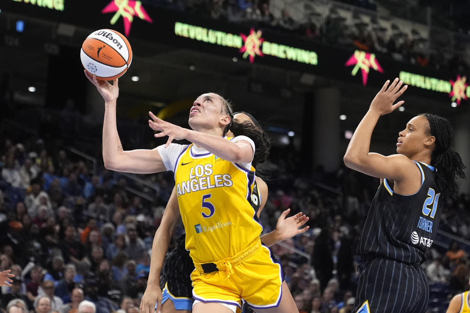 FILE - Los Angeles Sparks' Dearica Hamby (5) drives to the basket between Chicago Sky's Brianna Turner (21) and Isabelle Harrison during the first half of a WNBA basketball game Thursday, May 30, 2024, in Chicago. Hamby is replacing Los Angeles Sparks teammate Cameron Brink, who suffered a torn ACL last week, on the U.S. Olympic 3x3 basketball team. (AP Photo/Charles Rex Arbogast, File)