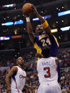Lakers guard Kobe Bryant (24) soars over Clippers guard Chris Paul (3) and Chauncey Billups while putting up a shot on Jan. 14 in Los Angeles. (Photo by Harry How/Getty Images)