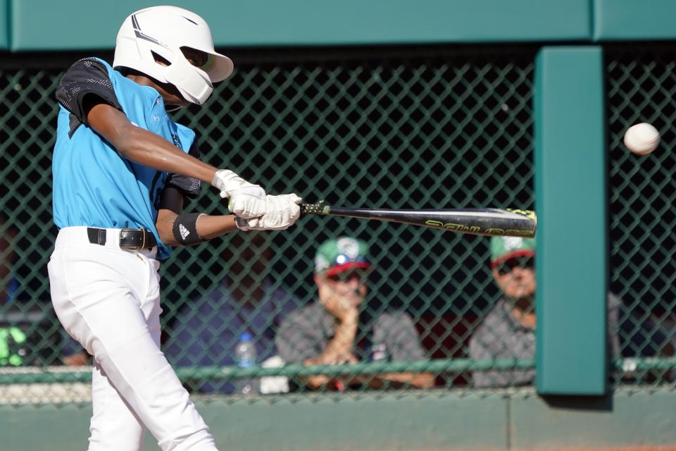 Curacao's Jaydion Louisa connects with a throw from Mexico pitcher David Zarate for a base hit, driving in two runs, during the fifth inning of a baseball game at the Little League World Series tournament in South Williamsport, Pa., Thursday, Aug. 25, 2022. (AP Photo/Tom E. Puskar)