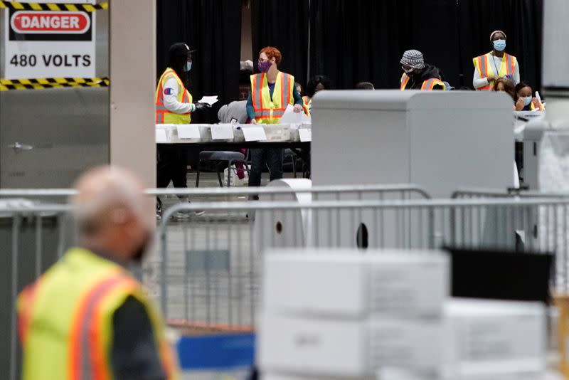 Electoral workers count postal ballots following the 2020 U.S. presidential election, in Philadelphia