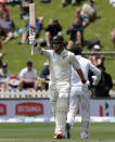 New Zealand's Tom Latham gestures with his bat as he celebrates after reaching 150 runs during play on day three of the first cricket test between New Zealand and Sri Lanka in Wellington, New Zealand, Monday, Dec. 17, 2018. (AP Photo/Mark Baker )