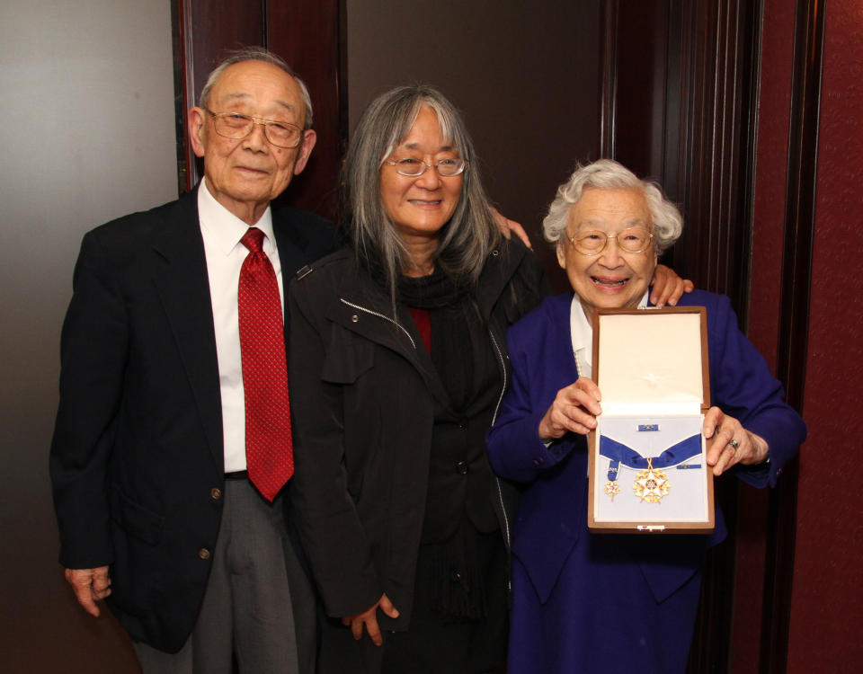 Homer Yasui, left, and Yuka Yasui Fujikura, right, Minoru Yasui's surviving siblings, with Min's daughter Holly Yasui, center. Yuka is holding the Presidential Medal of Freedom, posthumously awarded to Minoru. (Photo: Homer Yasui)