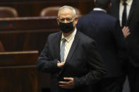 Israeli politician Benny Gantz stands during a Knesset session in Jerusalem Sunday, June 13, 2021. Bennett is expected later Sunday to be sworn in as the country's new prime minister, ending Prime Minister Benjamin Netanyahu's 12-year rule. (AP Photo/Ariel Schali22