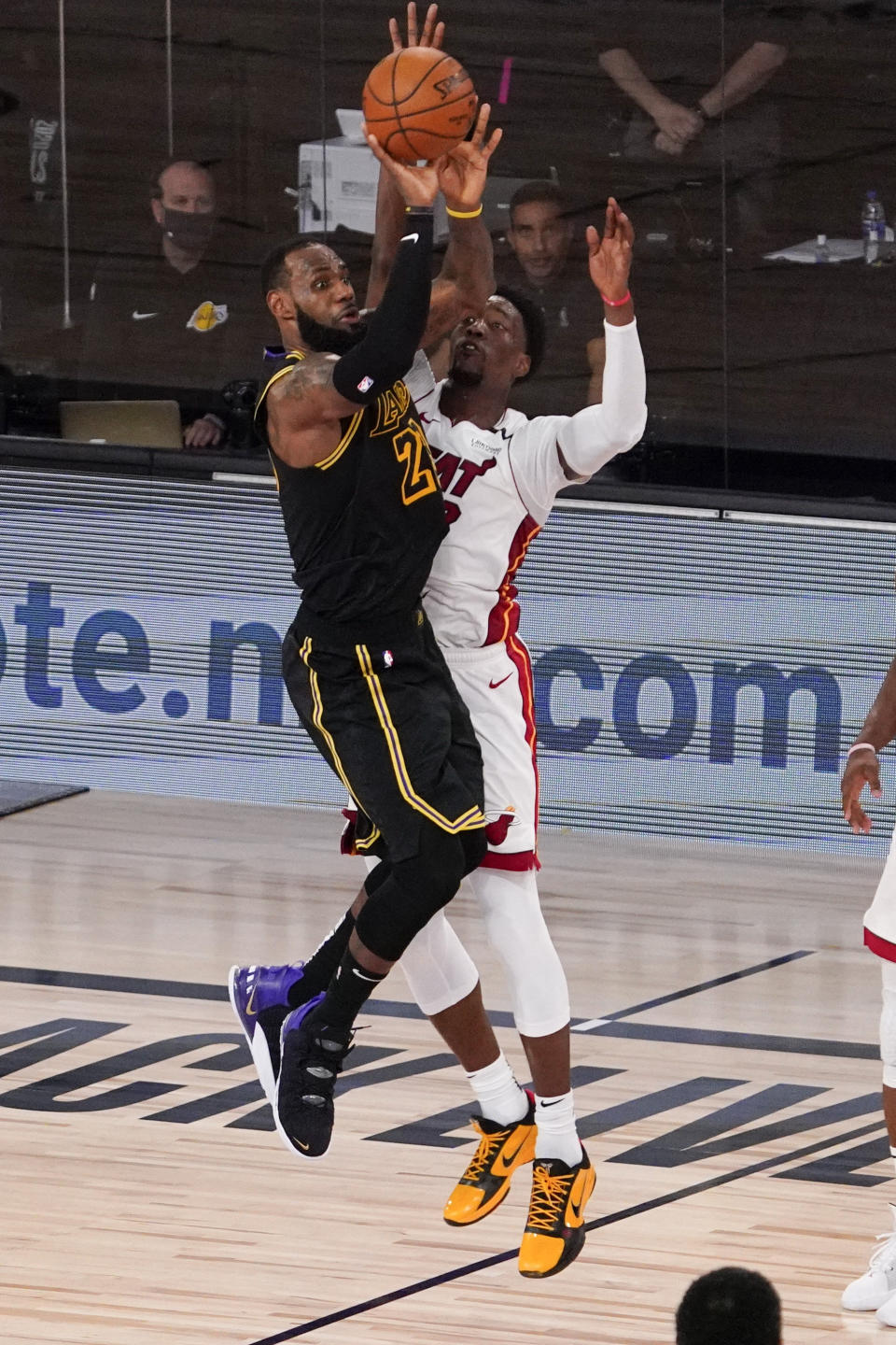 Los Angeles Lakers forward LeBron James misses the trying shot past Miami Heat forward Bam Adebayo during the second half in Game 5 of basketball's NBA Finals Friday, Oct. 9, 2020, in Lake Buena Vista, Fla. (AP Photo/Mark J. Terrill)