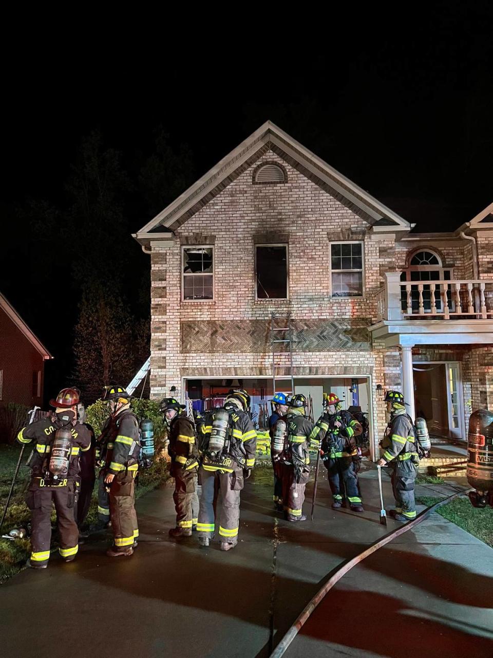 Fire fighters outside of home.