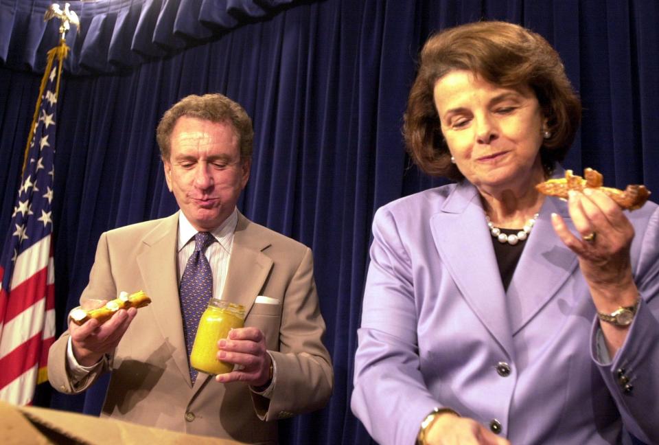 Sen. Arlen Specter, R-PA, presents pretzels and mustard from Philadelphia to Sen. Diane Feinstein, D-CA