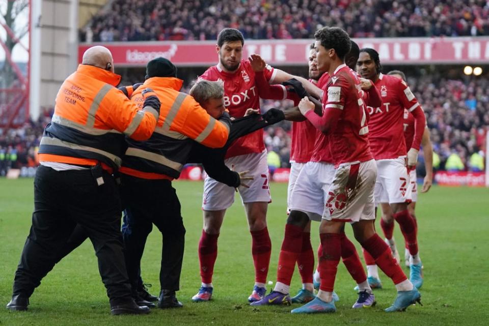 Stewards try to restrain a Leicester fan as he assaults Nottingham Forest players in an FA Cup tie earlier this season (Tim Goode/PA) (PA Wire)