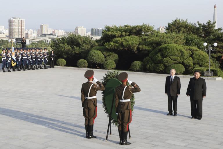 Russian President Vladimir Putin, second right, and North Korea's leader Kim Jong Un attend a wreath-laying ceremony at the Liberation Monument in Pyongyang, North Korea, on Wednesday, June 19, 2024. (Gavriil Grigorov, Sputnik, Kremlin Pool Photo via AP)