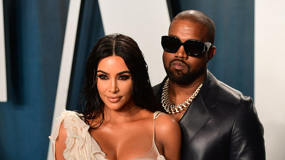 Kim Kardashian and Kanye West pose on the red carpet