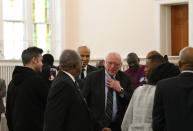 Sen. Cory Booker, D-N.J., and Sen. Bernie Sanders, I-Vt., greet people before a Martin Luther King Jr. prayer service at Zion Baptist Church in Columbia, S.C., on Monday, Jan. 21, 2019, during visits the state as they mull 2020 challenges to President Donald Trump. (AP Photo/Meg Kinnard)