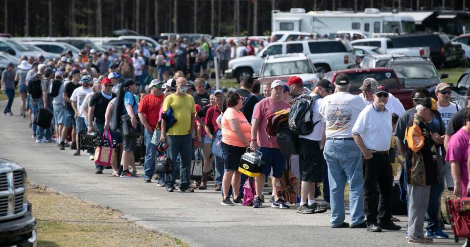 Hundreds of race fans wait in line to purchase tickets at the Ace Speedway on Saturday, May 23, 2020 in the rural Alamance County community of Altamahaw near Elon, N.C.