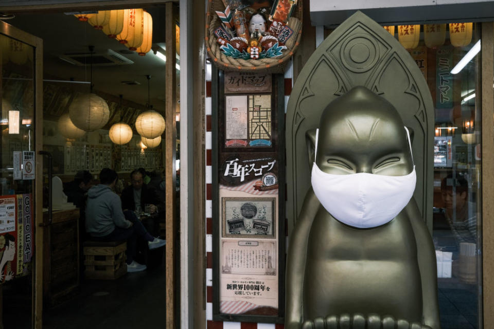 A statue in front of a restaurant wears a protective mask in the Shinsekai shopping district of Osaka, Japan, on Sunday, Nov. 29, 2020. <span class="copyright">Soichiro Koriyama/Bloomberg via Getty Images</span>