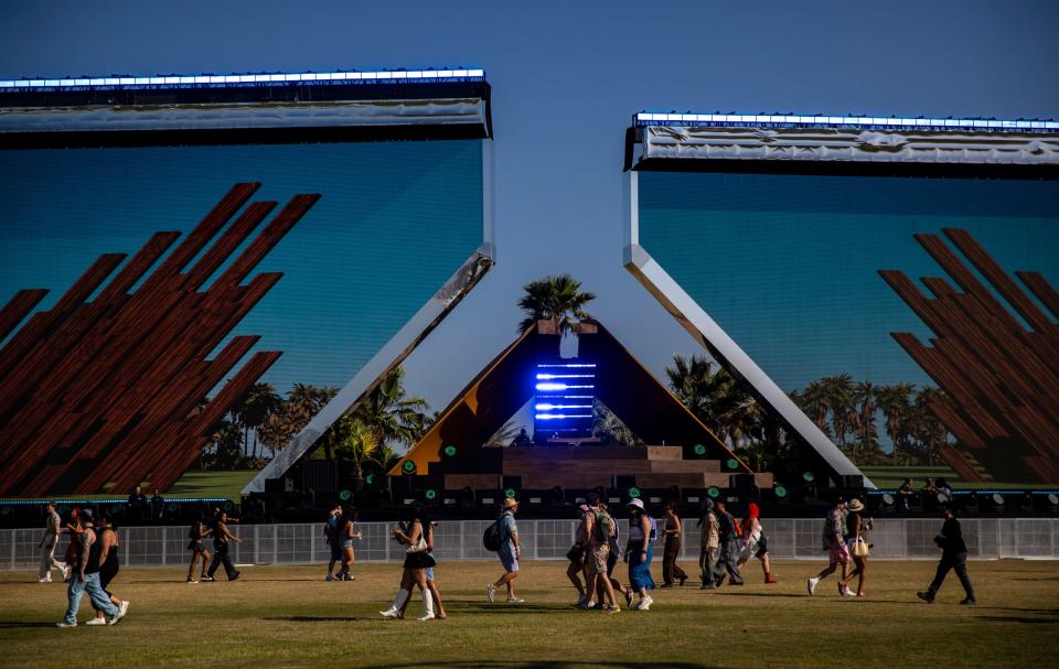 Festivalgoers walk by the Quasar Stage during the Coachella Valley Music and Arts Festival in Indio, Calif., Friday, April 12, 2024.