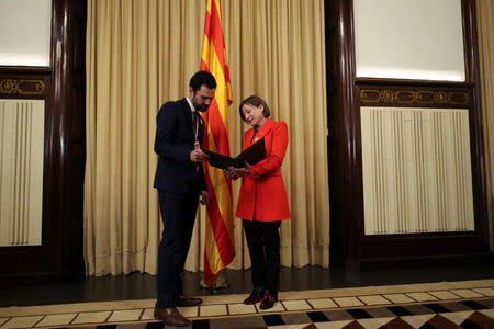 Roger Torrent (L), new Speaker of Catalan parliament, speaks with his predecessor Carme Forcadell after the first session of Catalan parliament in Barcelona, Spain, January 17, 2018. REUTERS/Albert Gea